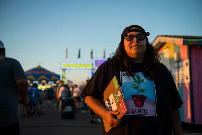 Giselle Ramirez stands with a clipboard, gathering signatures to support a petition to decriminalize marijuana in Lubbock at the South Plains Fair Monday, Sept. 25, 2023, in Lubbock.