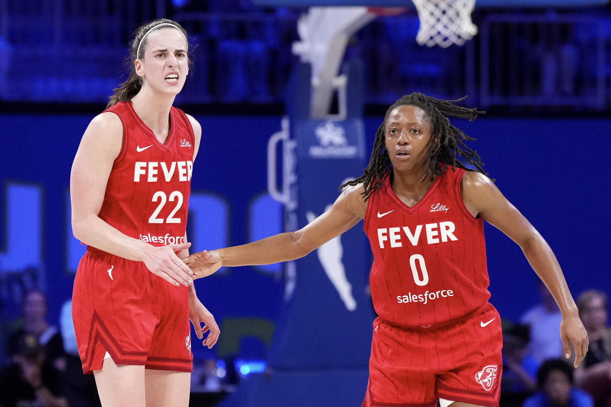 ARLINGTON, TEXAS - SEPTEMBER 01: Kelsey Mitchell #0 of the Indiana Fever celebrates scoring with Caitlin Clark #22 in the second half against the Dallas Wings at College Park Center on September 01, 2024 in Arlington, Texas. NOTE TO USER: User expressly acknowledges and agrees that, by downloading and or using this photograph, User is consenting to the terms and conditions of the Getty Images License Agreement. (Photo by Sam Hodde/Getty Images)