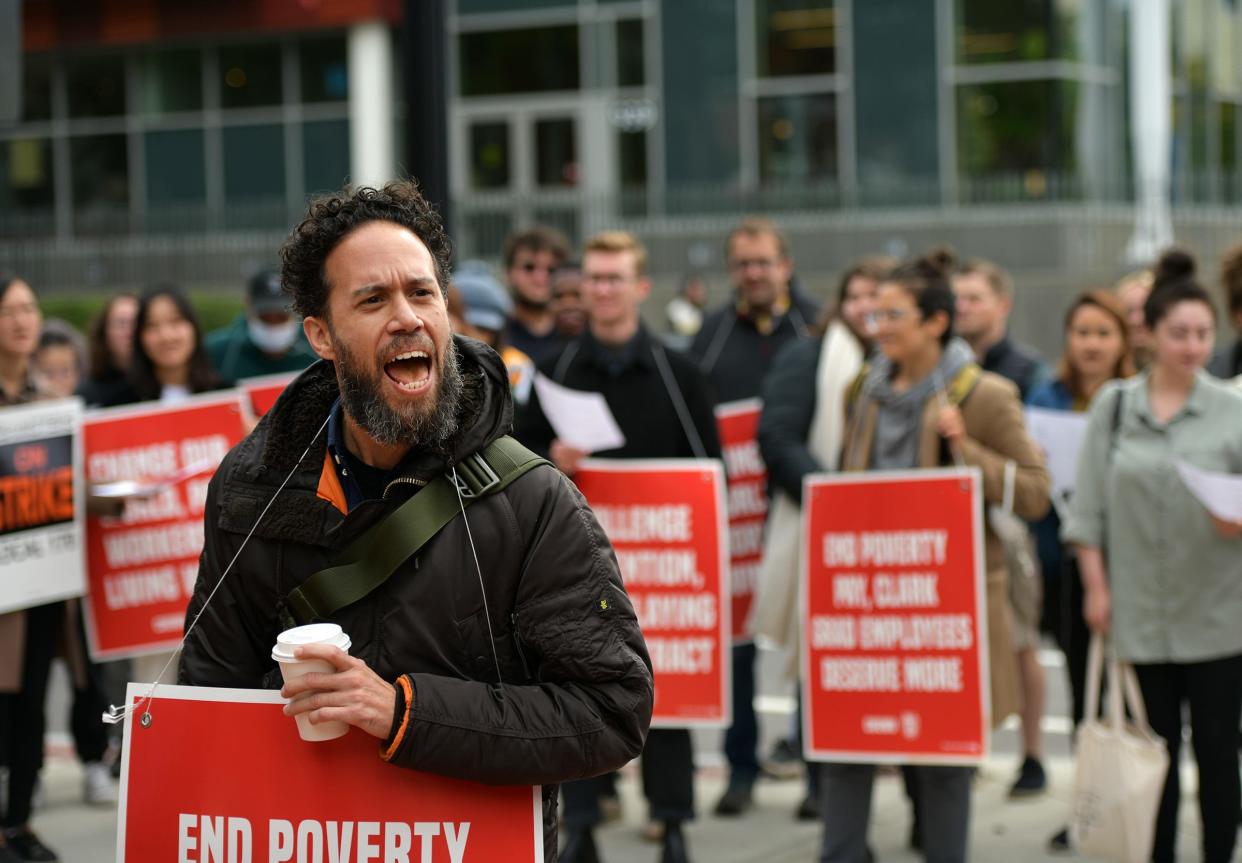 Richard Kruger Delgado shouts a chant to other striking Clark University graduate student workers after they walked off the job Monday in Worcester.