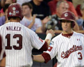OMAHA, NE - JUNE 25: Christian Walker #13 celebrates his run with Tanner English #3 of the South Carolina Gamecocks to tie the game 1-1 against the Arizona Wildcats in the seventh inning during game 2 of the College World Series at TD Ameritrade Field on June 25, 2012 in Omaha, Nebraska. (Photo by Harry How/Getty Images)