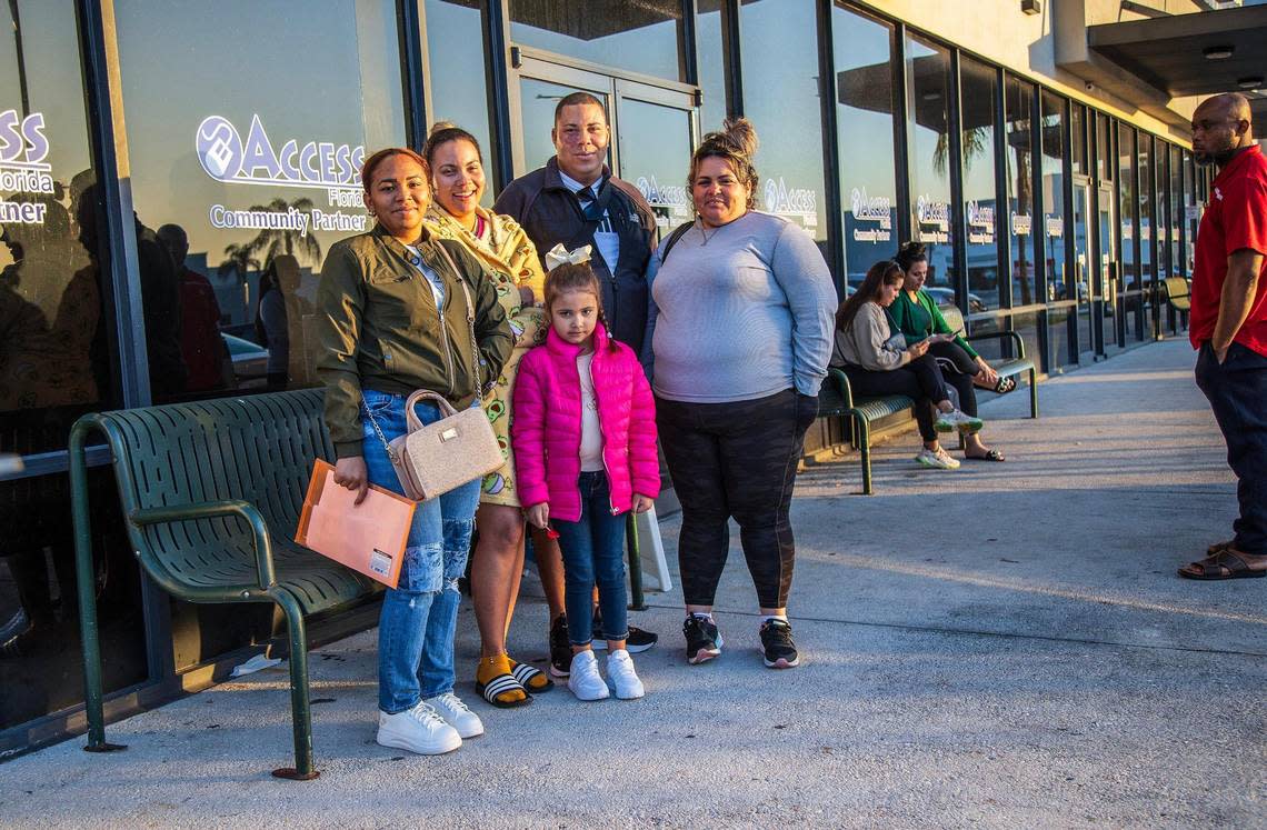 Areimy Montilla (second from left) posed with her Cuban migrant family who recently arrived, from left: Yulian Musderien, Ana Laura Montilla, Joseliel Montilla and Tatiana Valdez Roque, as they line up outside of the Hialeah’s Department of Children and Family offices located at 3805 W 20th Ave. on Wednesday, February 14, 2024. The family was looking to receive some benefits after entering the U.S. through the Mexican border amid an influx of migrants coming to Miami-Dade County. Pedro Portal/pportal@miamiherald.com