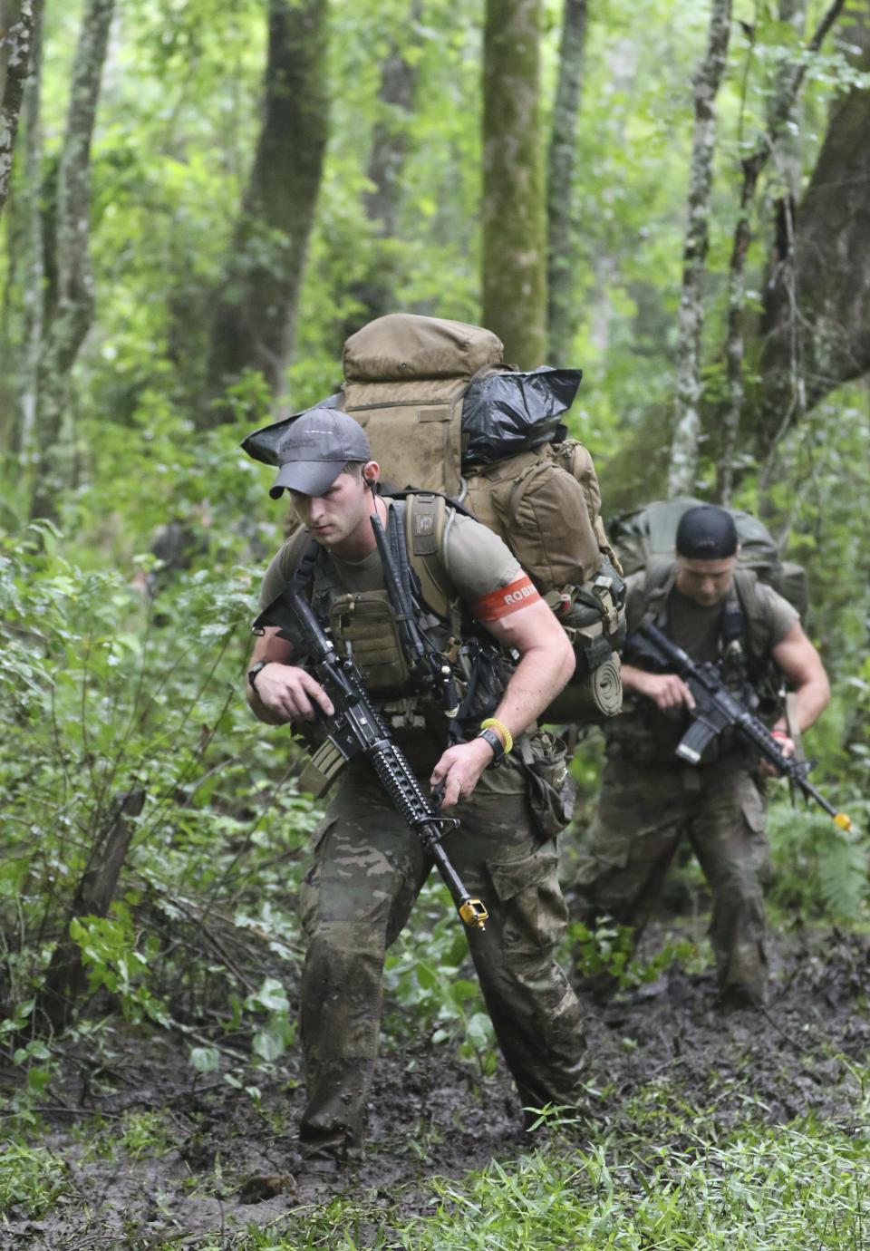 Special Forces candidates assigned to the U.S. Army John F. Kennedy Special Warfare Center and School patrol through a wooded area during the final phase of field training known as Robin Sage in central North Carolina, July 9, 2019. U.S. special operations commanders are having to do more with less and they're learning from the war in Ukraine, That means juggling how to add more high-tech experts to their teams while still cutting their overall forces by about 5,000 troops over the next five years. (Ken Kassens/U.S. Army via AP)
