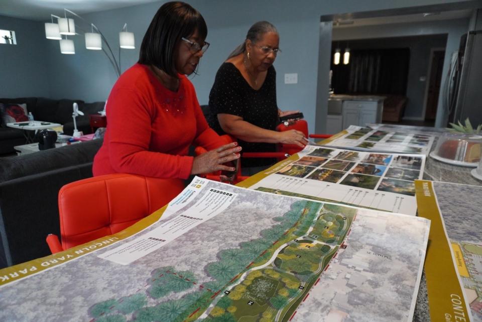 Oretha Walker, left, and Doris Edwards look at renditions from the city of Gainesville for plans of the Lincoln Yard Trail.