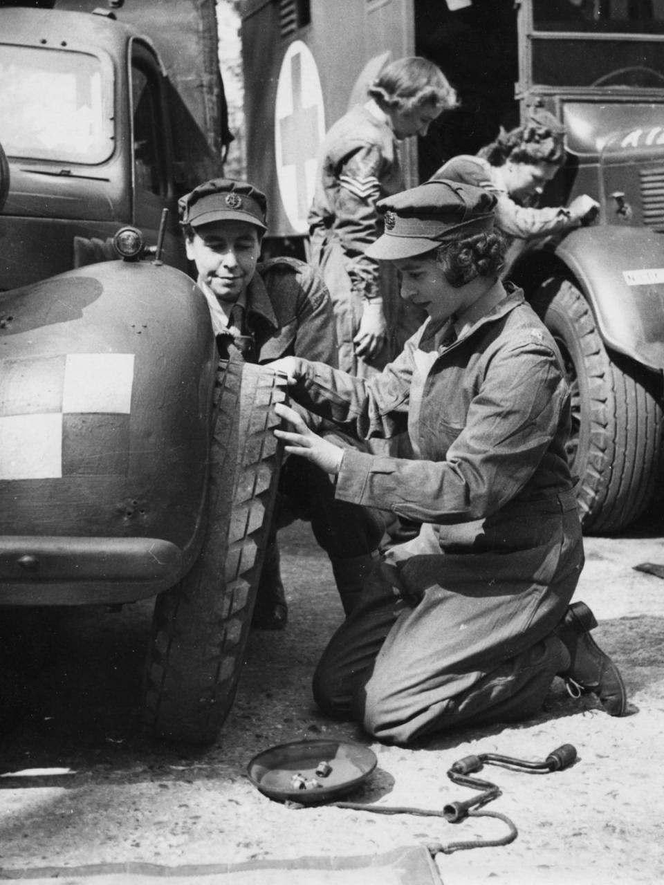 Just before the end of the war Elizabeth took part in training to become an ATS officer. She is pictured learning to  change a tire, 1945 (AFP/Getty)