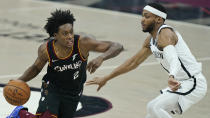 Cleveland Cavaliers' Collin Sexton, left, drives past Brooklyn Nets' Bruce Brown during the first half of an NBA basketball game, Wednesday, Jan. 20, 2021, in Cleveland. (AP Photo/Tony Dejak)