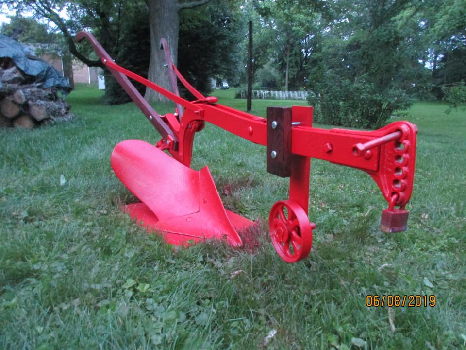 This plow was a lawn decoration in the yard of Kraig Ossler of Louisville when he purchased his house late in the 1990s. He replaced the handles, repainted it red, and allowed it to serve as a part of his landscaping in a flower bed.