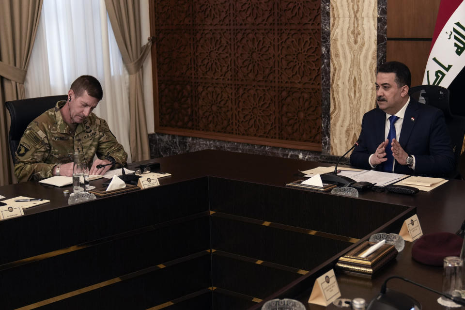 Iraqi Prime Minister Mohammed Shia al Sudani, right, and Major General Joel "J.B." Vowell attend the first round of the negotiations between Iraq and the United States to end the International Coalition mission in Baghdad, Iraq, Saturday, Jan. 27, 2024. (AP Photo/Hadi Mizban, Pool)