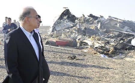 Egypt's Prime Minister Sherif Ismail looks at the remains of a Russian airliner after it crashed in central Sinai near El Arish city, north Egypt, October 31, 2015. REUTERS/Stringer