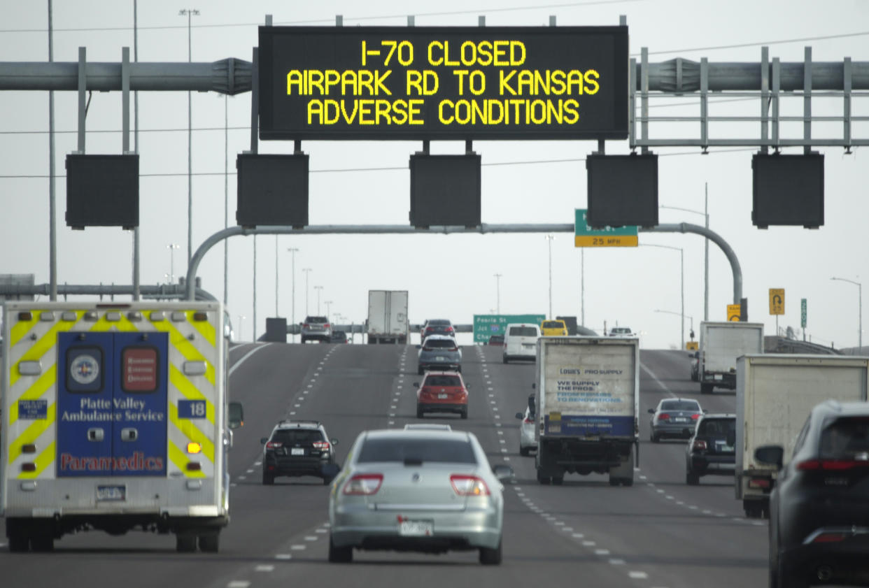An electronic sign advises motorists in the eastbound lanes of Interstate 70 that winter weather has forced the closure of the interstate Tuesday, Dec. 13, 2022, in Aurora, Colo. A massive winter storm has closed roads throughout northeast Colorado. (AP Photo/David Zalubowski)