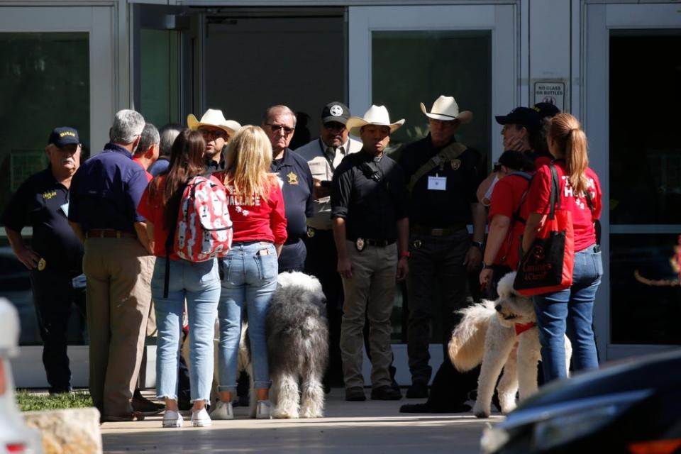 Police and members of the Brooke Army Medical Center Therapy Dogs unit gather outside of the Civic Center in Uvalde, Texas, Wednesday, May 25, 2022. The 18-year-old gunman who slaughtered 19 children and two teachers at a Texas elementary school barricaded himself inside a single classroom and “began shooting anyone that was in his way,” authorities said Wednesday in detailing the latest mass killing to rock the U.S. (AP Photo/Dario Lopez-Mills) (Copyright 2022 The Associated Press. All rights reserved)