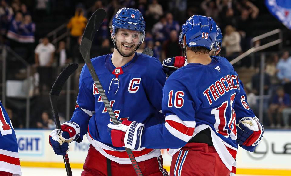 Sep 24, 2024; New York, New York, USA; New York Rangers defenseman Jacob Trouba (8) celebrates a goal with center Vincent Trocheck (16) during the third period against the New York Islanders at Madison Square Garden.