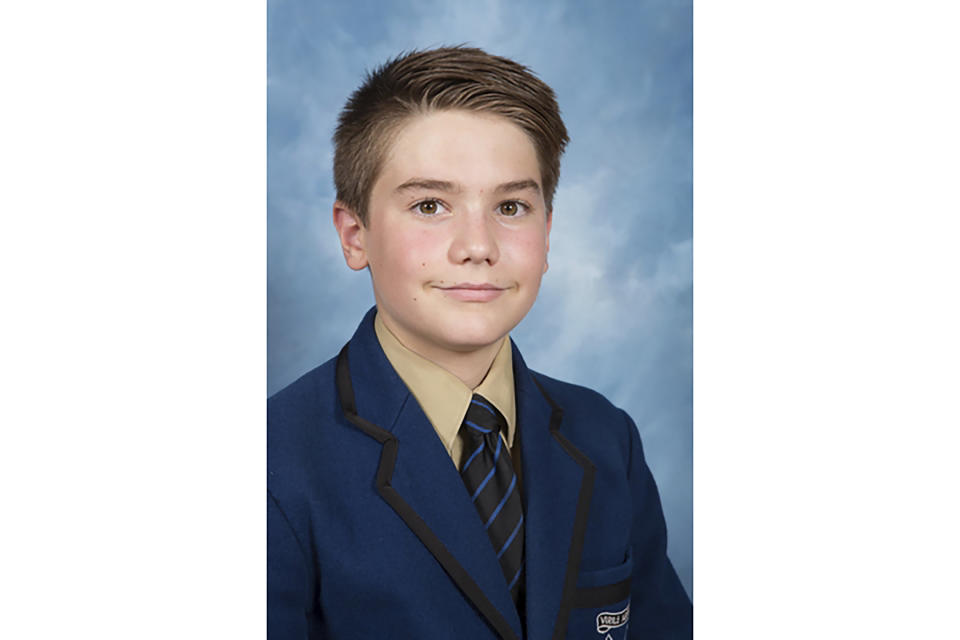 In this undated photo provided by his family/Knox Grammar School, Matthew Hollander poses for a class photo in Sydney, Australia. Hollander died in a hospital from injuries after a volcano erupted near Whakatane, New Zealand, Monday, Dec. 9, 2019. (Family/Knox Grammar School via AP)