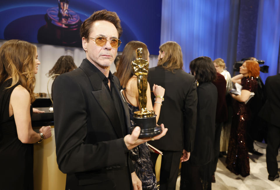 Robert Downey Jr. holding his Oscar for Best Supporting Actor in 2024