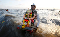 <p>A devotee carries an idol of the Hindu god Ganesh, the deity of prosperity, to immerse into the Arabian Sea on the fifth day of Ganesh Chaturthi festival in Mumbai, India, September 17, 2018. REUTERS/Francis Mascarenhas </p>