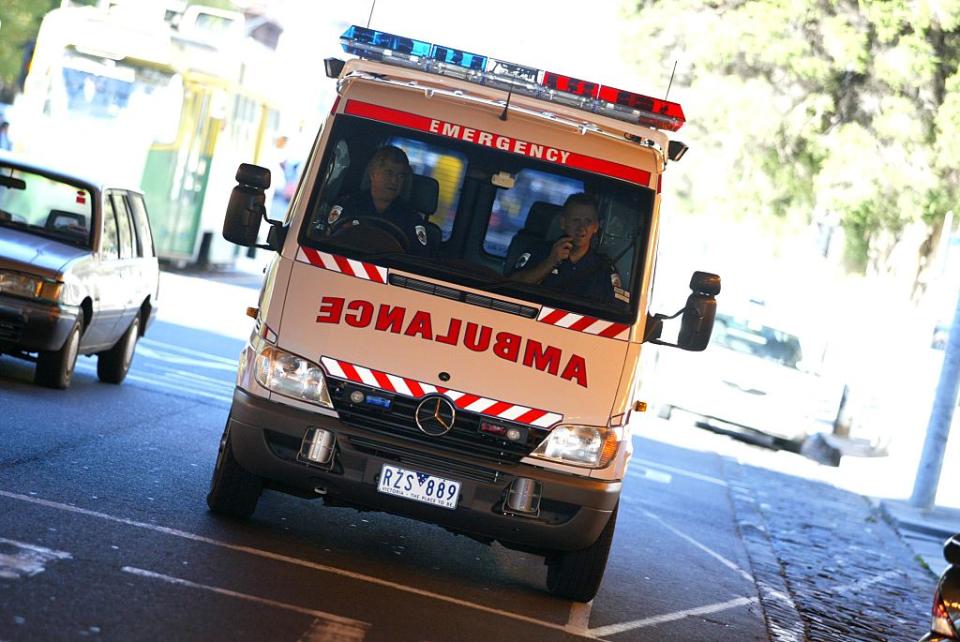 An ambulance leaves a Melbourne hospital, 24 May 2003.