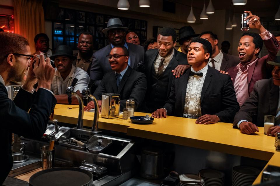 Malcolm X (Kingsley Ben-Adir, from left) takes a picture of his friends Jim Brown (Aldis Hodge), Cassius Clay (Eli Goree) and Sam Cooke (Leslie Odom Jr.) in "One Night in Miami."