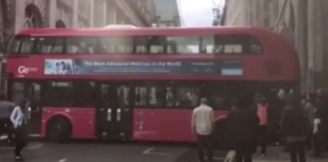 Double-decker bus gets wedged in London street