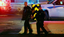 Police officers patrol the perimeter near a mosque after a shooting in Quebec City. REUTERS/Mathieu Belanger