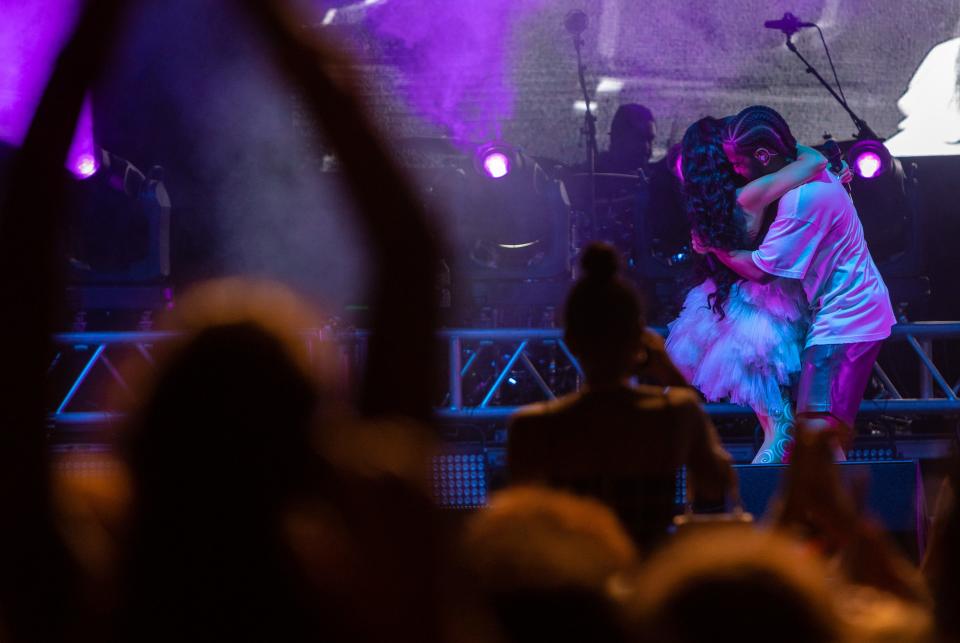 Big Sean hugs his girlfriend, R&B singer Jhené Aiko, during their performance on the Grande Stage during the Mo Pop Festival at Detroit's Hart Plaza on Sunday, July 31, 2022.