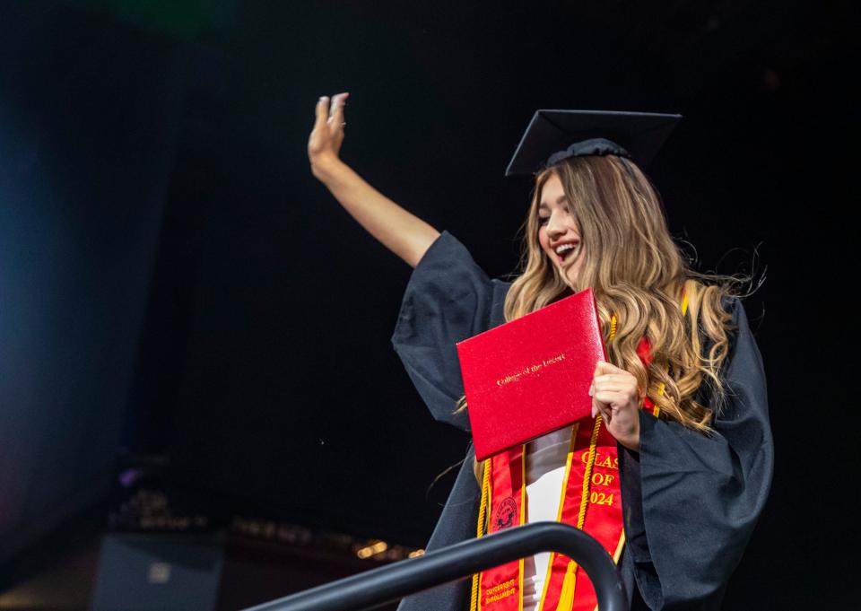 Adriana Garcia waves to the crowd after receiving her diploma during the 2024 College of the Desert Commencement ceremony at Acrisure Arena in Palm Desert, Calif., Tuesday, May 21, 2024.