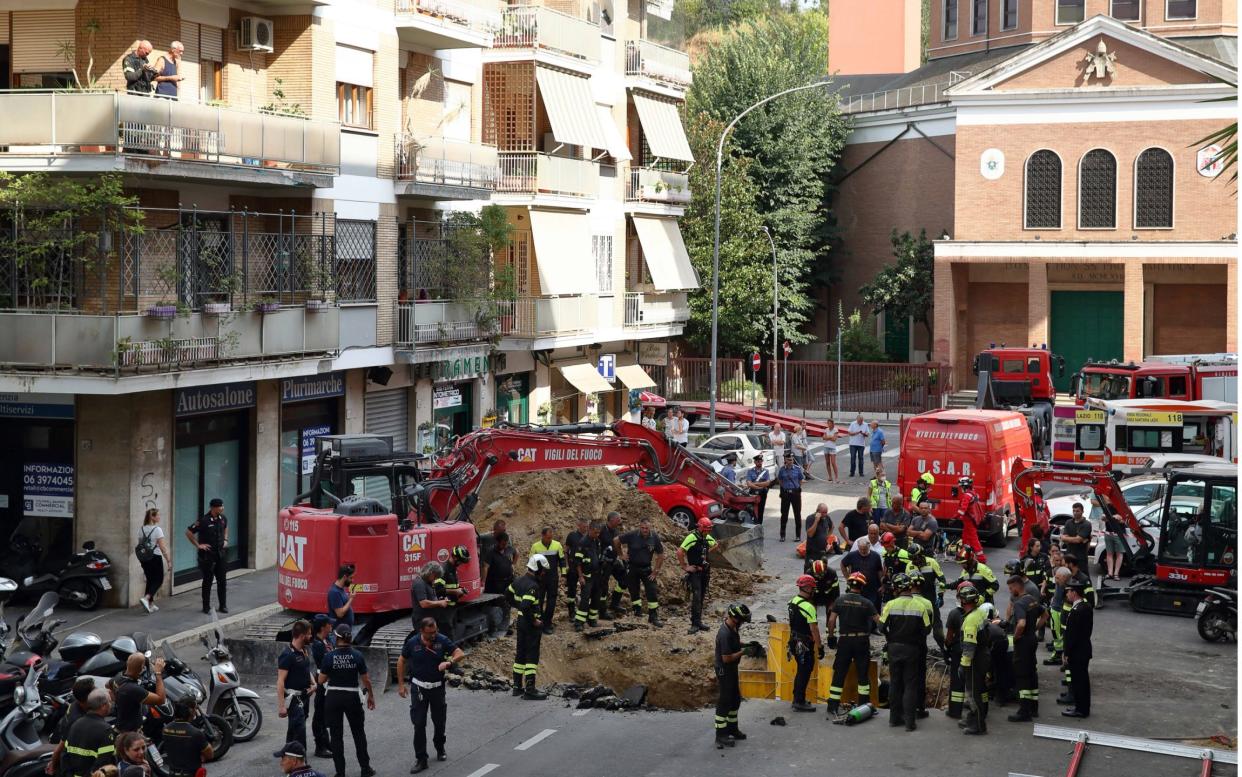 Firefighters carry out the rescue operation in Via Innocenzo XI, named after 17th century pope Innocent XI - Shutterstock