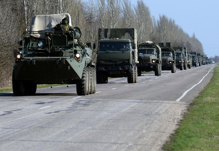 Russian forces drive on a highway near the Ukrainian town of Dzhankoy, on March 15, 2014