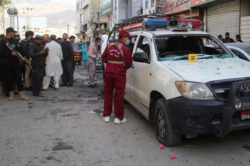 A member of the crime scene unit surveys after a blast in Quetta
