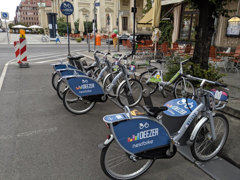 Deezer bikes, Lidl bikes, and a Lime scooter in the Mitte neighborhood. (Yahoo Finance)