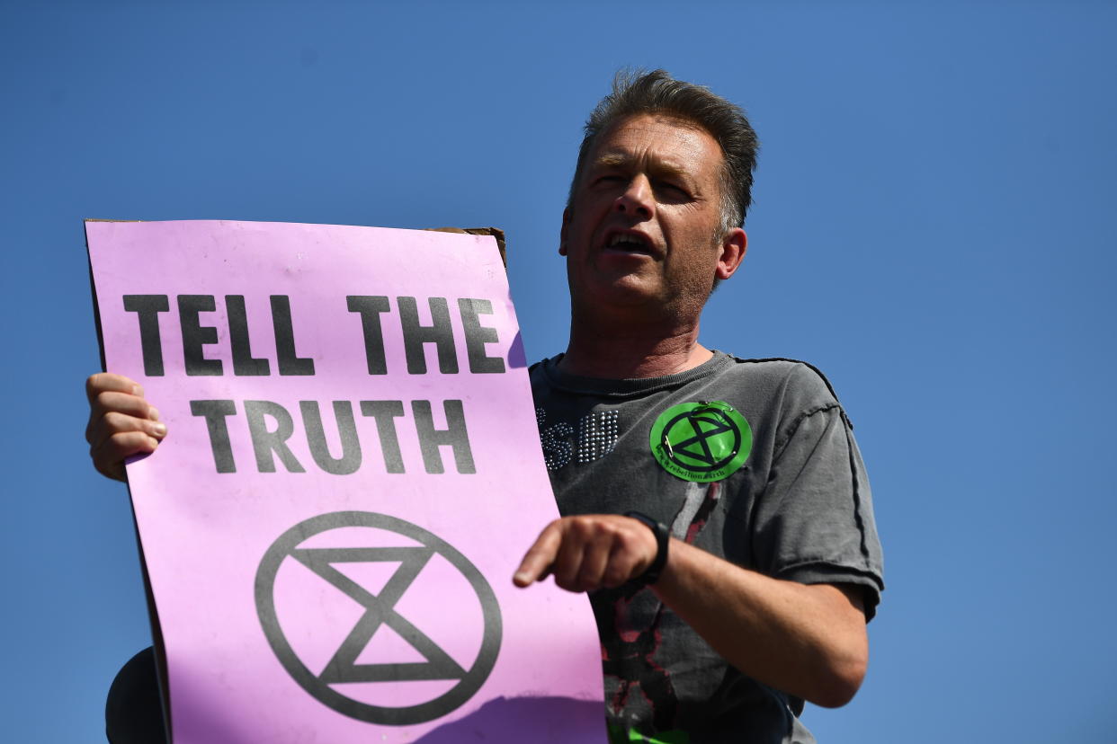 Chris Packham makes a speech on top of a bus stop during the Extinction Rebellion demonstration on Waterloo Bridge in London. (Photo by Victoria Jones/PA Images via Getty Images)