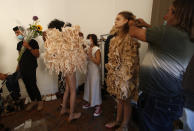 Models wear creations part of the Claudia Gisele 2021 women's spring-summer collection at the "We are Made in Italy - Black Lives Matter in Italian fashion Collection" event during the Milan's fashion week in Milan, Italy, Thursday, Sept. 17, 2020. (AP Photo/Antonio Calanni)