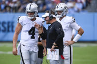 Las Vegas Raiders head coach Josh McDaniels talks with quarterback Derek Carr (4) in the second half of an NFL football game against the Tennessee Titans Sunday, Sept. 25, 2022, in Nashville, Tenn. (AP Photo/Mark Zaleski)