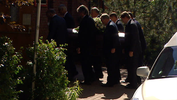 Pallbearers carry Peter Lougheed's coffin into the church on Thursday for a private funeral.