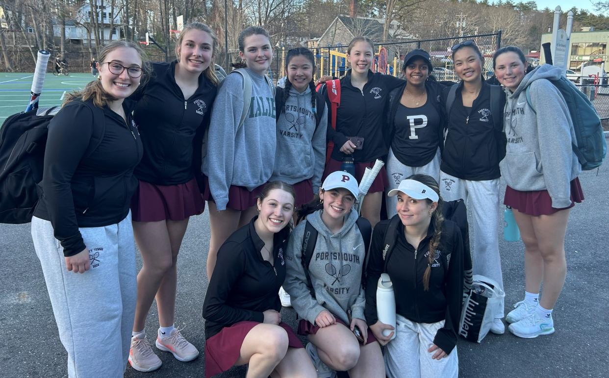 Members of the Portsmouth High School girls tennis team celebrate after beating Kingswood, 8-1 on Tuesday in a Division II match in Wolfeboro.