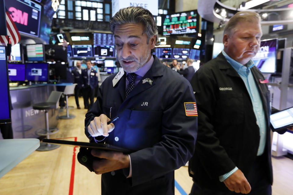 Traders John Romolo, left, and George Ettinger work on the floor of the New York Stock Exchange, Friday, Aug. 16, 2019. Stocks are opening broadly higher at the end of a turbulent week. (AP Photo/Richard Drew)