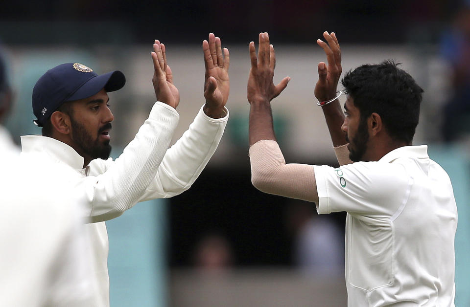 India's Jasprit Bumrah, right, celebrates with teammate K.L. Rahul after bowling out Australia's Peter Handscomb on day 4 of their cricket test match in Sydney, Sunday, Jan. 6, 2019. (AP Photo/Rick Rycroft)