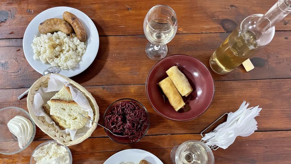 a table with plates of food and glasses of water