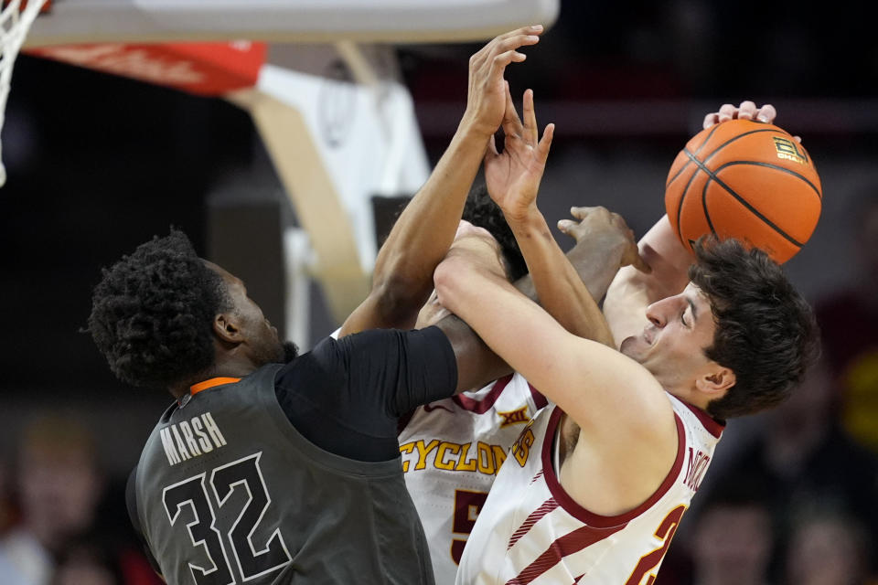 Oklahoma State center Mike Marsh (32) fights for a rebound with Iowa State forward Milan Momcilovic, right, during the second half of an NCAA college basketball game, Saturday, Jan. 13, 2024, in Ames, Iowa. Iowa State won 66-42. (AP Photo/Charlie Neibergall)