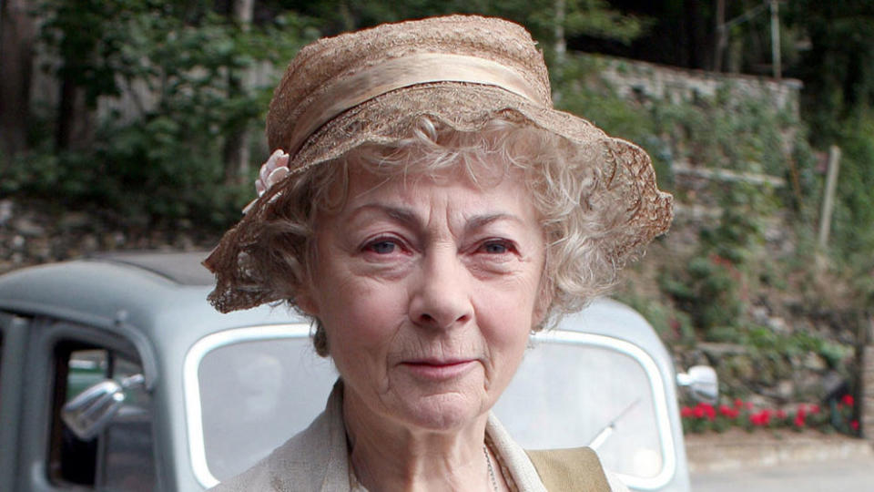 An image from Marple shows an elderly white lady wearing a hat, this is miss marple and she will solve your murder!