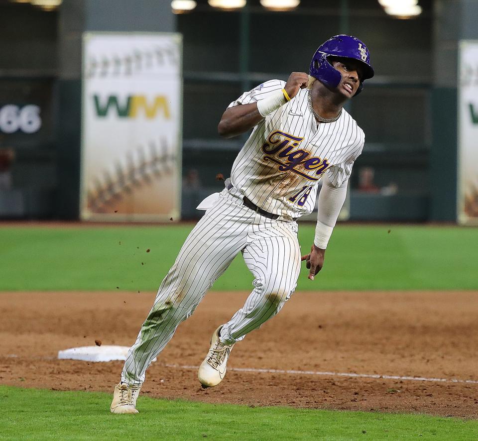 HOUSTON, TEXAS - MARCH 04: Tre' Morgan #18 of the LSU Tigers rounds third base on his way to scoring in the tenth inning on a double from Cade Doughty #4 against the Oklahoma Sooners during the Shriners Children's College Classic at Minute Maid Park on March 04, 2022 in Houston, Texas. (Photo by Bob Levey/Getty Images)