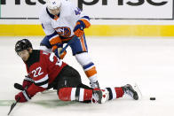New Jersey Devils defenseman Ryan Murray (22) and New York Islanders center Jean-Gabriel Pageau (44) get tangled up during the second period of an NHL hockey game, Sunday, Jan. 24, 2021, in Newark, N.J. (AP Photo/Kathy Willens)