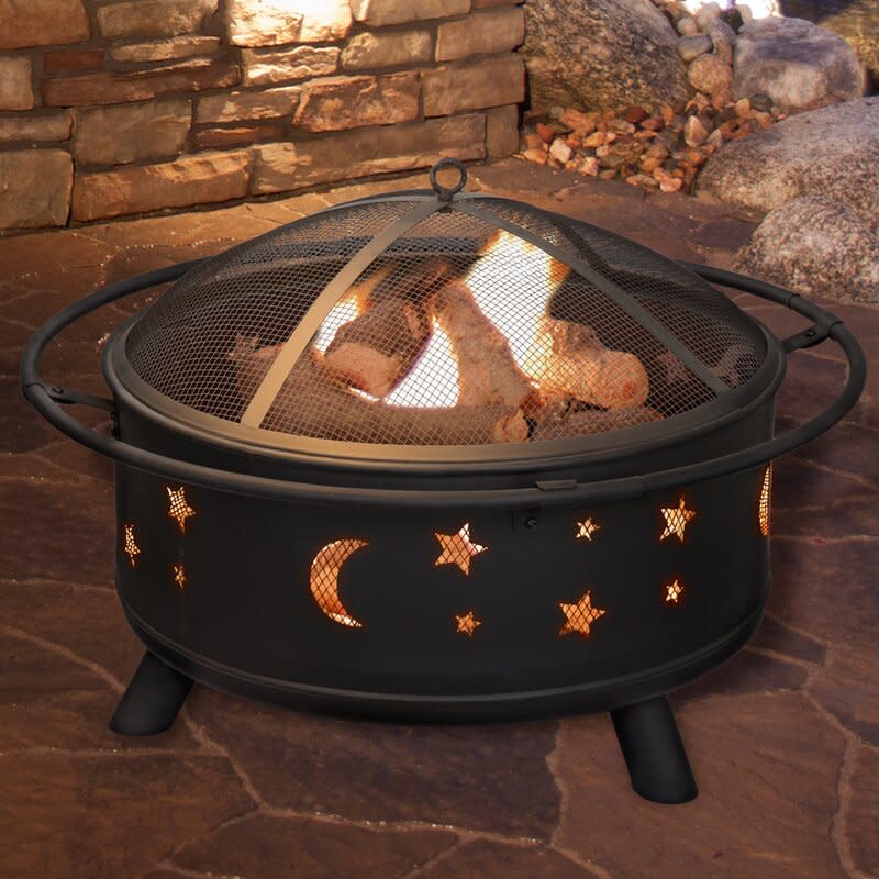 Jackman Star and Moon Steel Wood Burning Fire Pit (Credit: Wayfair)