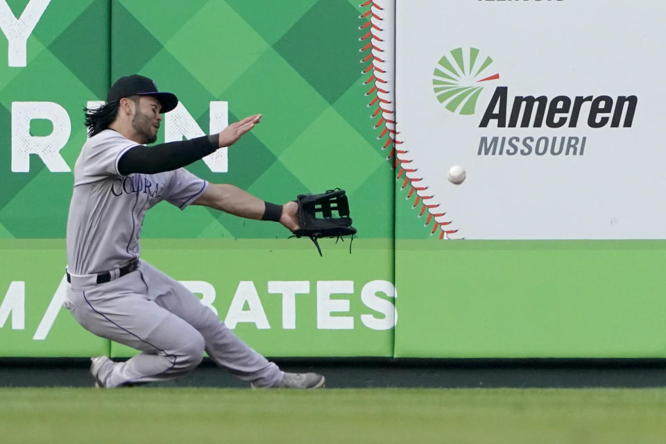 Colorado Rockies left fielder Connor Joe is unable to catch a ground-rule double by St. Louis Cardinals' Nolan Arenado during the XXXX inning of a baseball game Wednesday, Aug. 17, 2022, in St. Louis. (AP Photo/Jeff Roberson)