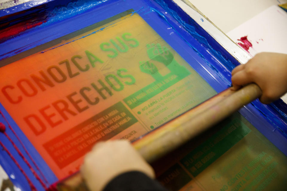 A young artist with Self Help Graphics & Art prints posters for renters reading “Conozca Sus Derechos” (Know Your Rights) during an event hosted by the East Side Leads at the Wellness Center in Boyle Heights, Los Angeles. (Photo: Patrick T. Fallon for Yahoo News)