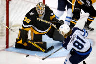 Winnipeg Jets' Kyle Connor (81) has a shot blocked by Pittsburgh Penguins goaltender Tristan Jarry during the first period of an NHL hockey game in Pittsburgh, Sunday, Jan. 23, 2022. (AP Photo/Gene J. Puskar)