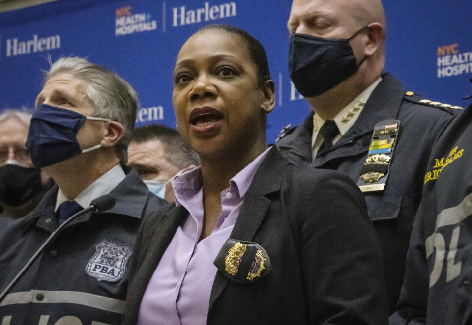 FILE - New York City Police Commissioner Keechant Sewell, center, speaks during a news conference at a Harlem hospital after the shooting of two NYPD officers, Jan. 21, 2022, in New York. Manhattan District Attorney Alvin Bragg, after conferring with Sewell, made clear on Friday, Feb. 4, 2022, that gunpoint and knifepoint stickups at stores and other commercial places will be prosecuted as felonies, updating a controversial policy memo he put out days after taking office last month. (AP Photo/Yuki Iwamura)