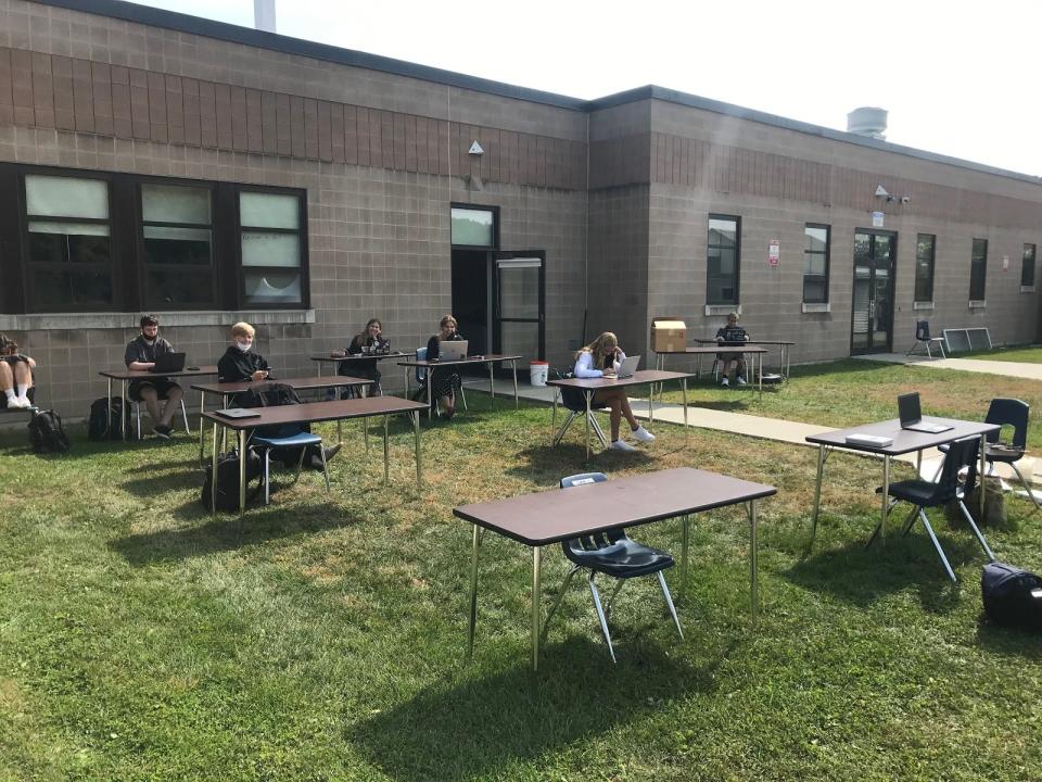 Champlain Valley Union High School students complete work at separate tables while limiting the spread of COVID-19 by being outside during the 2020-2021 school year. Being physically distant and masked for school learning twice a week has made it tougher for teens to maintain find ways to socialize.