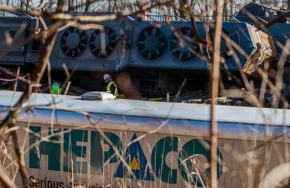 Work begins on a train derailment cleaned up Tuesday, Jan. 18, 2022, in Avon, Ind.