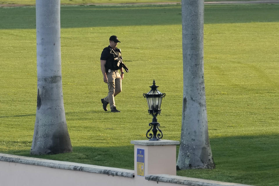 A Secret Service agent patrols on the property of former President Donald Trump's Mar-a-Lago estate, Sunday, April 2, 2023, in Palm Beach, Fla. Trump was indicted by a Manhattan grand jury Thursday. (AP Photo/Lynne Sladky)