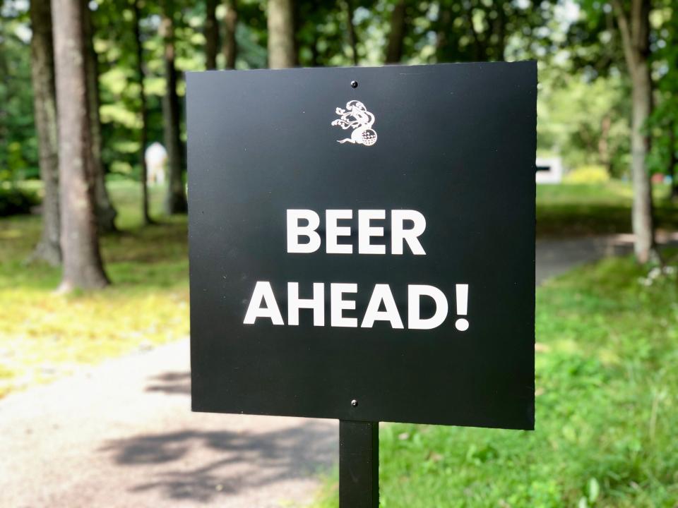 A sign points golfers to what they truly came for at Tree House Tewksbury.
