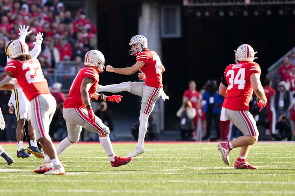 Nov 26, 2022; Columbus, Ohio, USA;  Ohio State Buckeyes punter Jesse Mirco (29) gets off a punt over wide open tight end Mitch Rossi (34) during the second half of the NCAA football game against the Michigan Wolverines at Ohio Stadium. Ohio State lost 45-23. Mandatory Credit: Adam Cairns-The Columbus Dispatch
